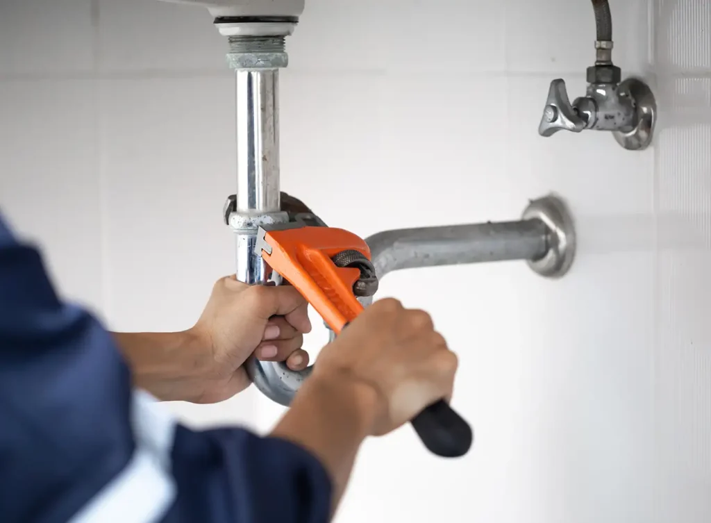 plumber performing plumbing maintenance on pipes springfield il